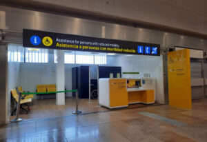 Airport reduced mobility assistance desk for people with reduced mobility at Terminal 2 of Adolfo Suárez Madrid-Barajas Airport.