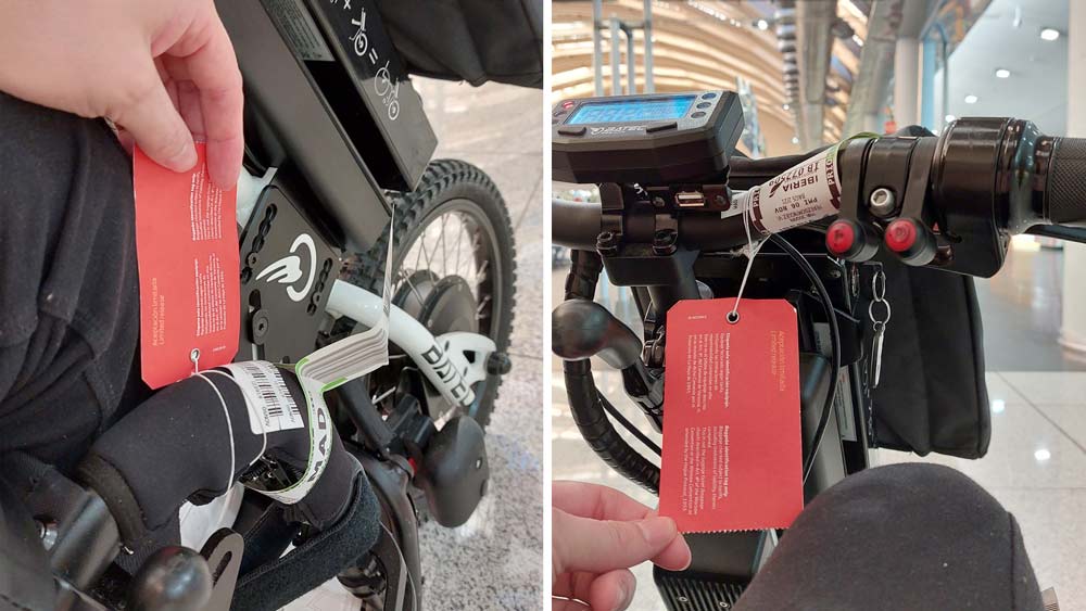 Wheelchair and Batec handbike with check-in tags at the airport before travelling by plane.