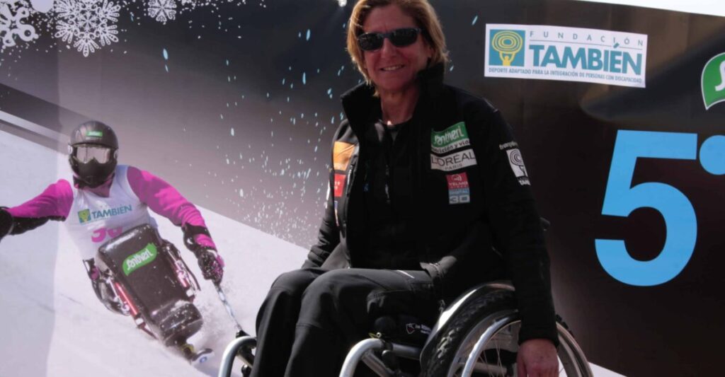 Woman in a wheelchair practising adapted alpine skiing.