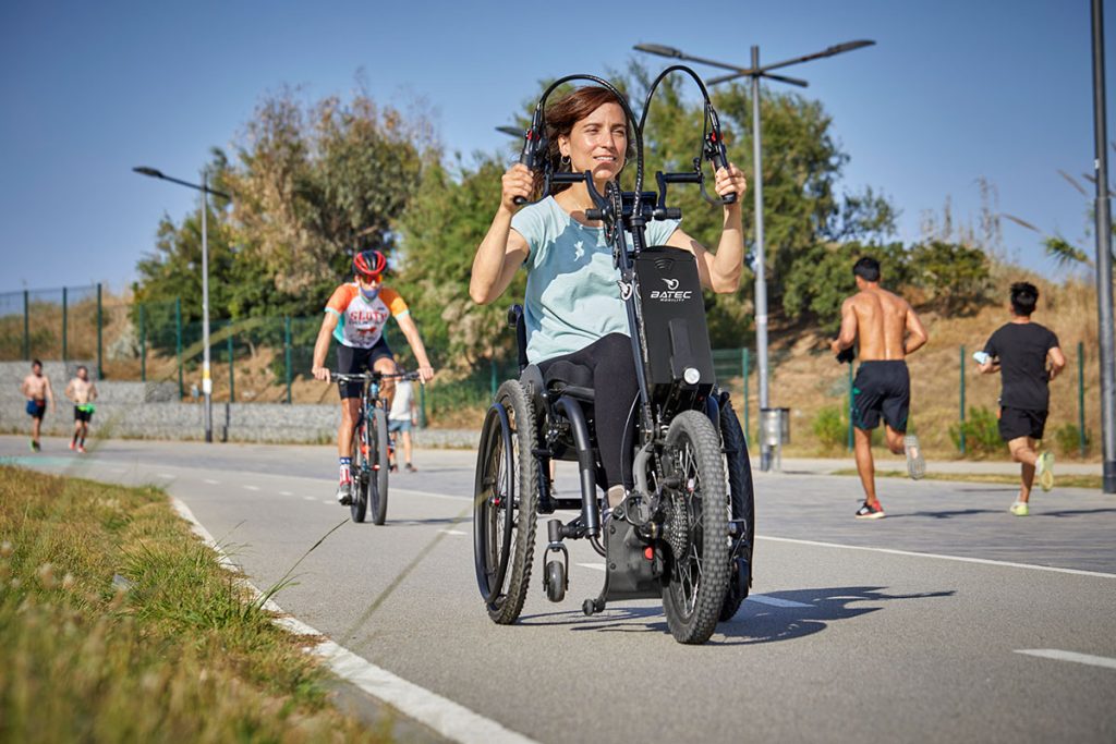 mujer en silla de ruedas haciendo deporte con su handbike batec hibrid 2
